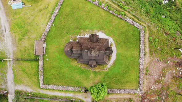 Top View Of Gol Stave Church In Oslo, Norway Situated On A Green Grassy Field - descending drone sho