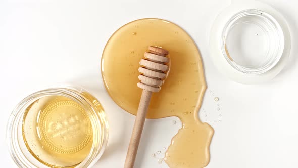 Rotation of the Composition with Fresh Honey on a White Background Top View