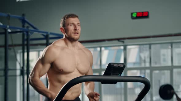 Male athlete athlete is doing cardio training on a treadmill, bodybuilder is running