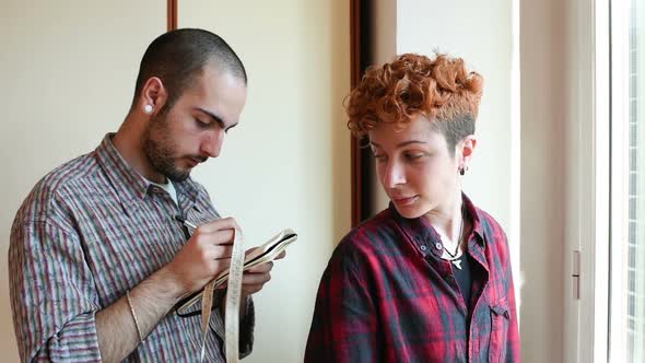 Young male fashion designer working on garment