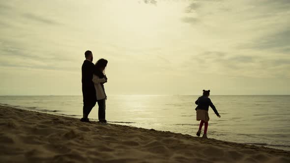 Parents Child Relaxing Together on Beach Vacation