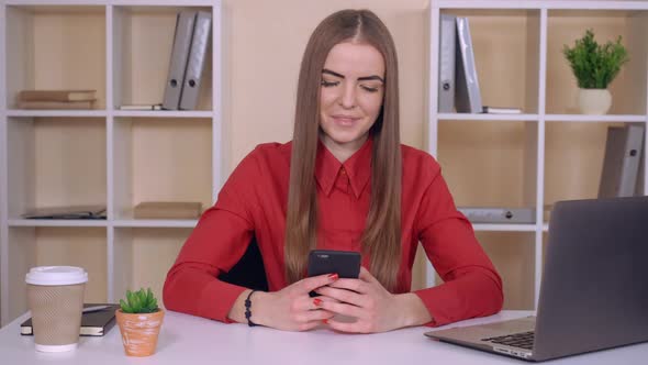 Female Texting Sms on Cellular Indoors