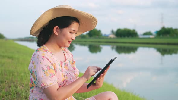 Asian woman using portable device during vacation. Portable technology concept.
