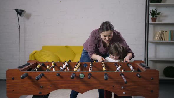 Happy Carefree Family Playing Table Soccer at Home