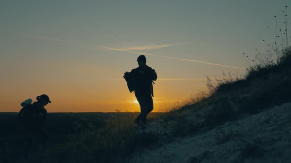 Couple Hiking Help Each Other Silhouette in Mountains. Teamwork Couple Hiking, Help Each Other