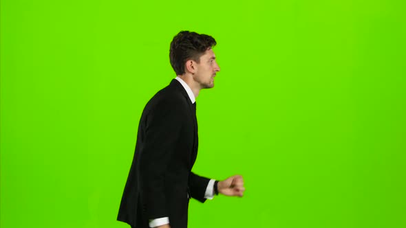 Businessman Is a Telephone Rings To Him and He Talks. Green Screen