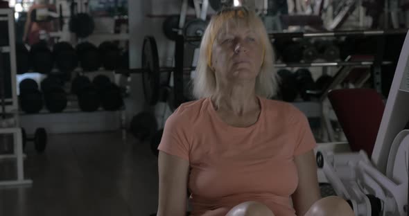 Mature woman training on back extension machine