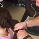 Master Man Makes Pigtails on Head of Young Girl - VideoHive Item for Sale