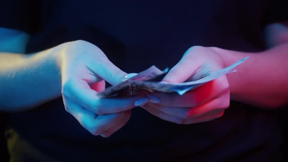 Counting American Fifty Dollar Banknotes on Black Background