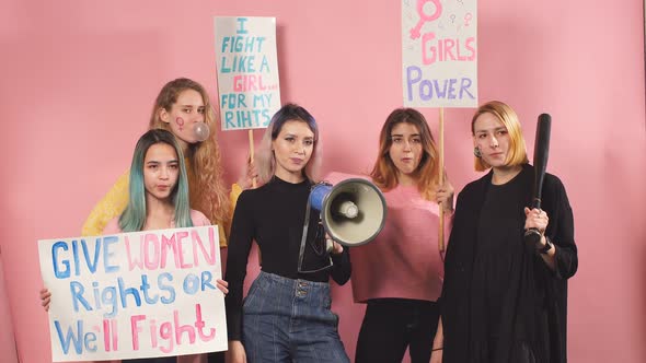 Feminism Concept. Five Young Girls Feminists Advocating Feminism Isolated Over Pink Background