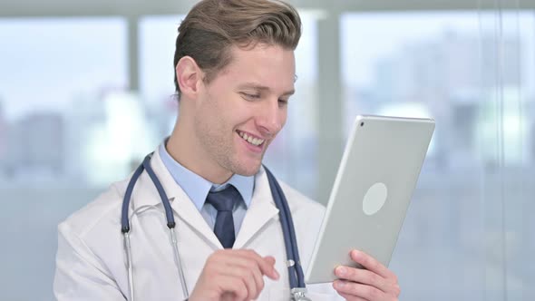 Portrait of Cheerful Young Male Doctor Doing Video Chat on Tablet