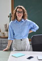 Young happy woman teacher coach standing at desk in classroom office. Portrait - PhotoDune Item for Sale