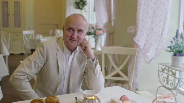 Elegant Senior Man in Cafe