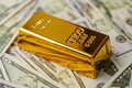 Gold bar on US dollar bill banknotes. Buying gold bars for investment. - PhotoDune Item for Sale