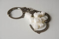 Handcuffs with white sugar cubes on the table. Sugar addiction concept. - PhotoDune Item for Sale