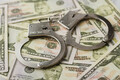 Police handcuffs on dollar bills. Crime and bribery concept with handcuffs. - PhotoDune Item for Sale