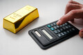 Man using calculator for buying a gold bar. Buying gold bars for investment. - PhotoDune Item for Sale