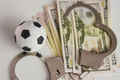Soccer ball with money and handcuffs. Corruption in football, gambling and betting concept. - PhotoDune Item for Sale