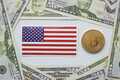 Golden bitcoin BTC and flag of the United States of America USA on the table. - PhotoDune Item for Sale