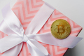 Golden bitcoin on the pink gift box ribbon. Cryptocurrency concept. - PhotoDune Item for Sale