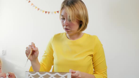 Mother and child make christmas decorations together.