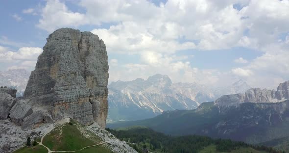 Aerial drone view of a man and woman couple mountain climbing on top of a tower.