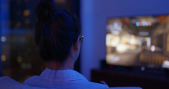 Woman play tv game at home in the evening