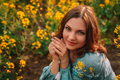 Smiling ukrainian woman in embroidery vyshyvanka blouse in yellow canola field. - PhotoDune Item for Sale