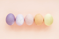 Pastel colored Easter eggs on peach background. - PhotoDune Item for Sale
