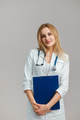 Young European Female Doctor Portrait with stethoscope and folder wearing white robe - PhotoDune Item for Sale