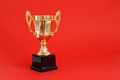 Golden Winner prize Cup on Red background. - PhotoDune Item for Sale