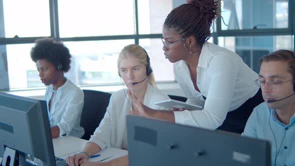 Young African American Manager Helping Call Center Employees