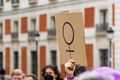 Women hands supporting feminist symbol placard on 8 M demonstration - PhotoDune Item for Sale
