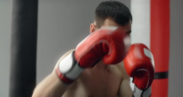 Boxer Man in Red Boxing Gloves Does Shadow Boxing and Trains at Boxing Club Fighter Man is Fighting