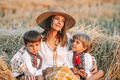 Beautiful ukrainian family - woman sons in vyshyvanka shirts on hay, countryside - PhotoDune Item for Sale