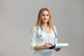 Young European Female Doctor Portrait with stethoscope and folder wearing white robe - PhotoDune Item for Sale