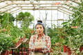 Confident Hispanic Woman In Greenhouse - PhotoDune Item for Sale
