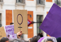Women hands supporting feminist symbol placard on 8 M demonstration - PhotoDune Item for Sale