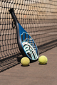Padel racket and balls near net - PhotoDune Item for Sale