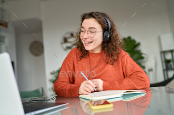 online on computer at home. Young smiling woman using laptop remote working, talking having web conference meeting, virtual class, web seminar.
