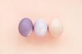 Pastel colored Easter eggs on peach background. - PhotoDune Item for Sale