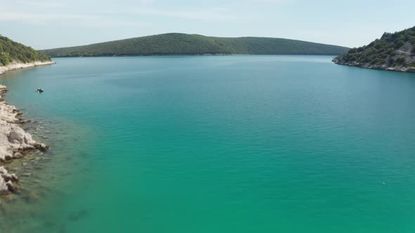 Drone flying over ship wreck, showing beautiful landscape behind wreck. Medium wide to super wide sh