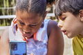 mobile phone handled by interested multiethnic children - PhotoDune Item for Sale
