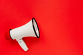 White megaphone on red background. Alarm and announcement - PhotoDune Item for Sale