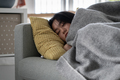 Sick Asian woman sleeping on sofa under blanket at home, recovering from flu - PhotoDune Item for Sale
