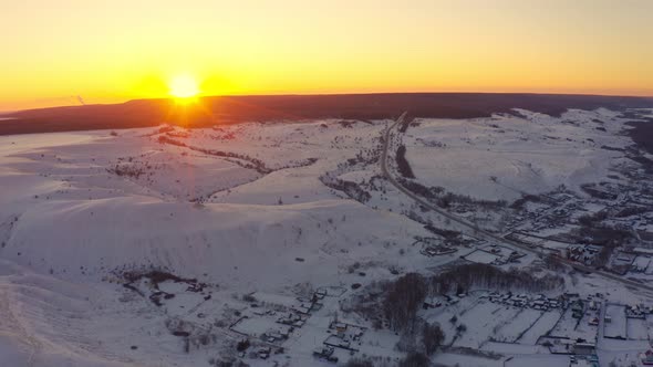 The Sun Peeks Out From Behind the Mountains at Dawn in the Winter