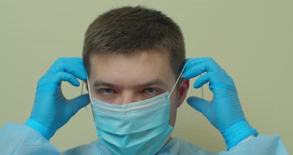 Pandemic Protection of the Covid-19 Coronavirus. Portrait of a Young Male Doctor in a Medical Face