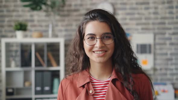 Slow Motion Portrait of Attractive Young Lady Smiling Standing in Modern Office