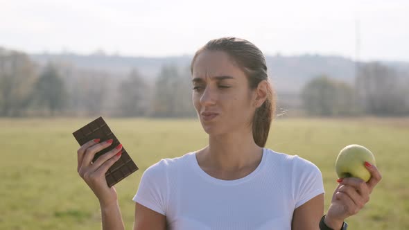 Girl Trying To Choose Between French Fries And Avocado.