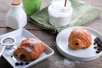 Fresh Baked Chocolate Croissants (Pain au Chocolat) with Milk for Breakfast.